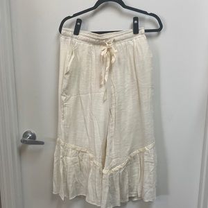 Umgee crop cream lined pants. Rayon and polyester with lace and ruffle.